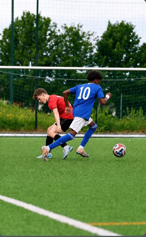 Player in blue number 10 taking on a defender